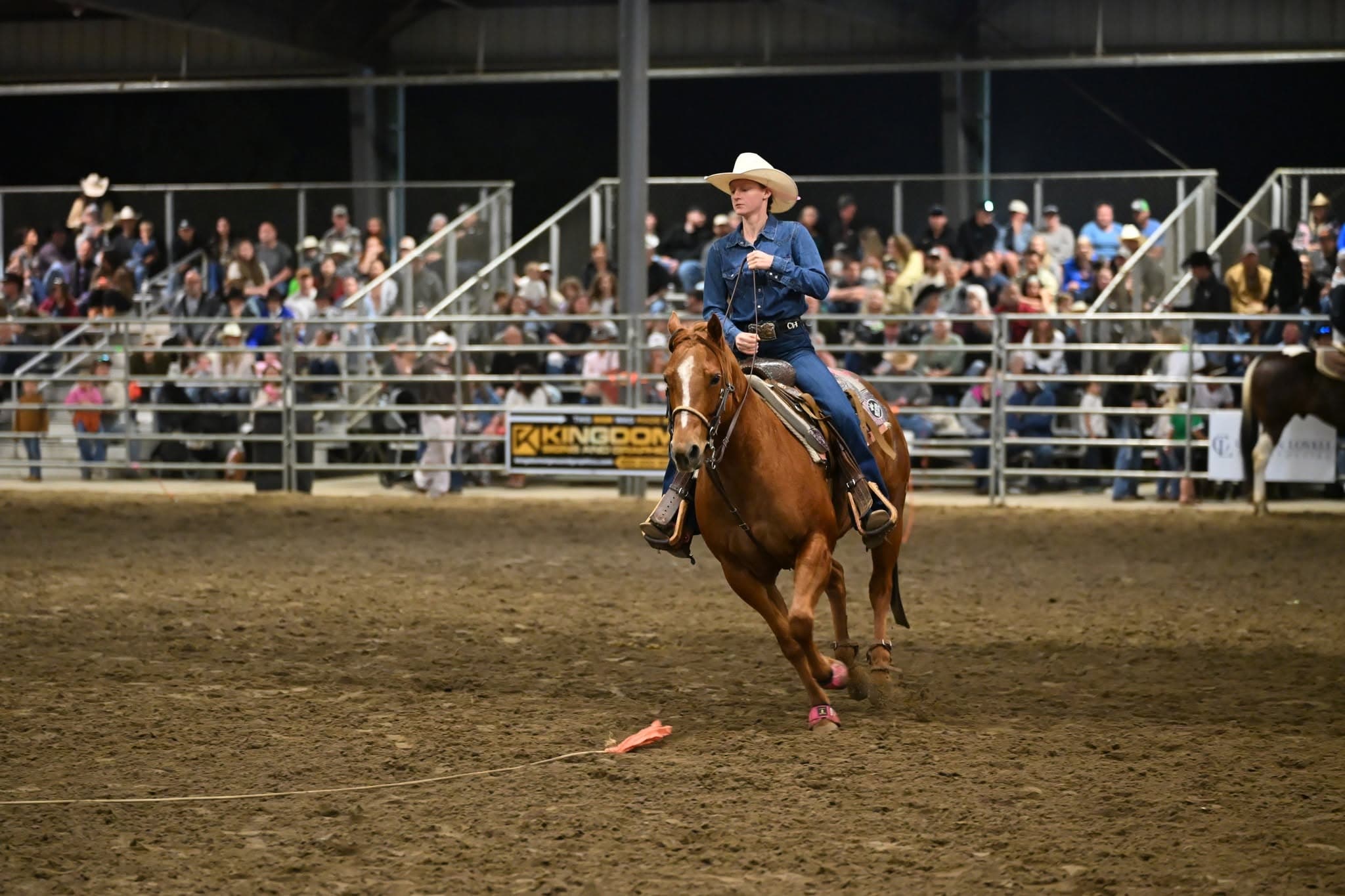 Rodeo competitor riding through the arena